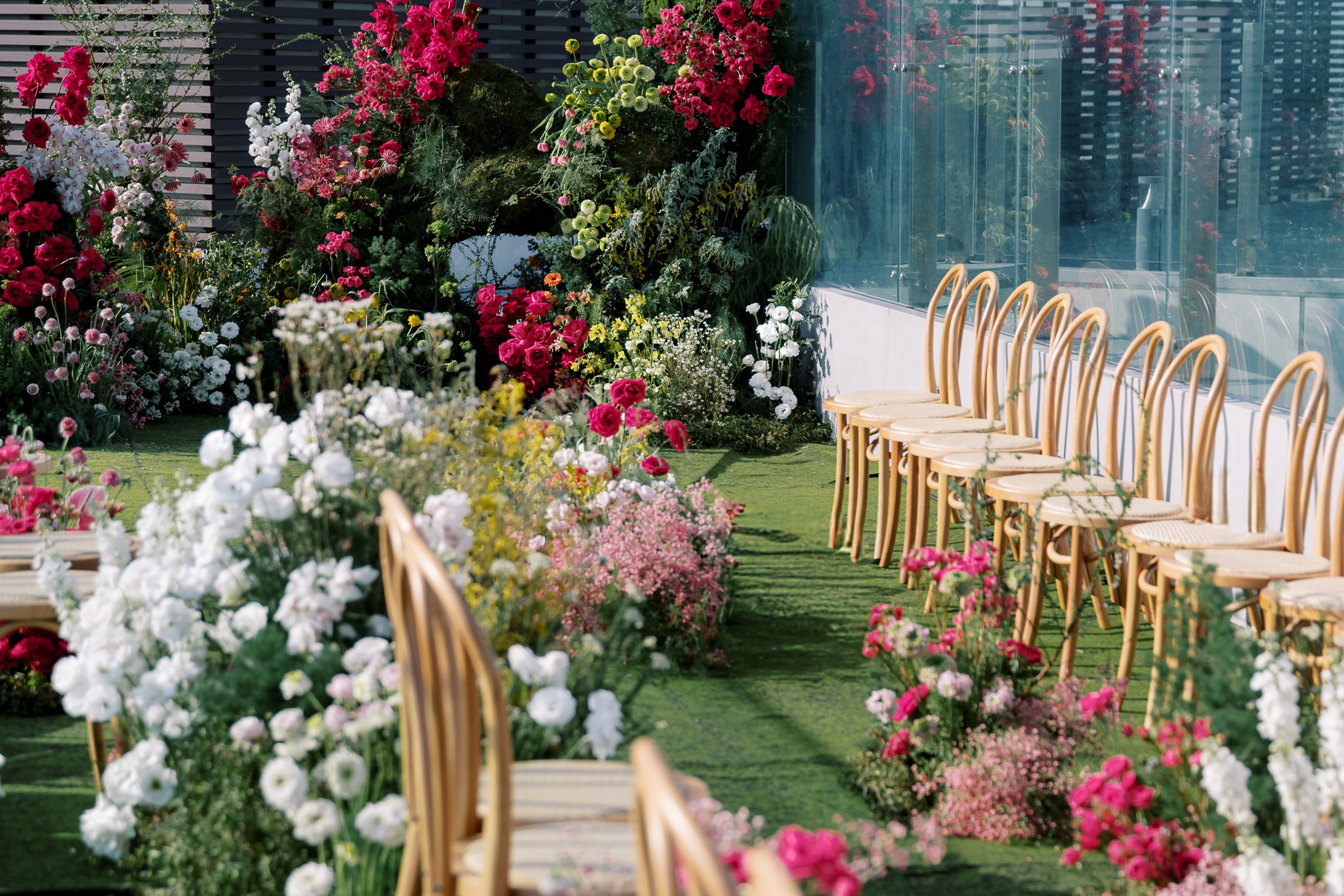 The sixth-floor Outdoor Garden, arranged for a daytime ceremony beside the glass facade.